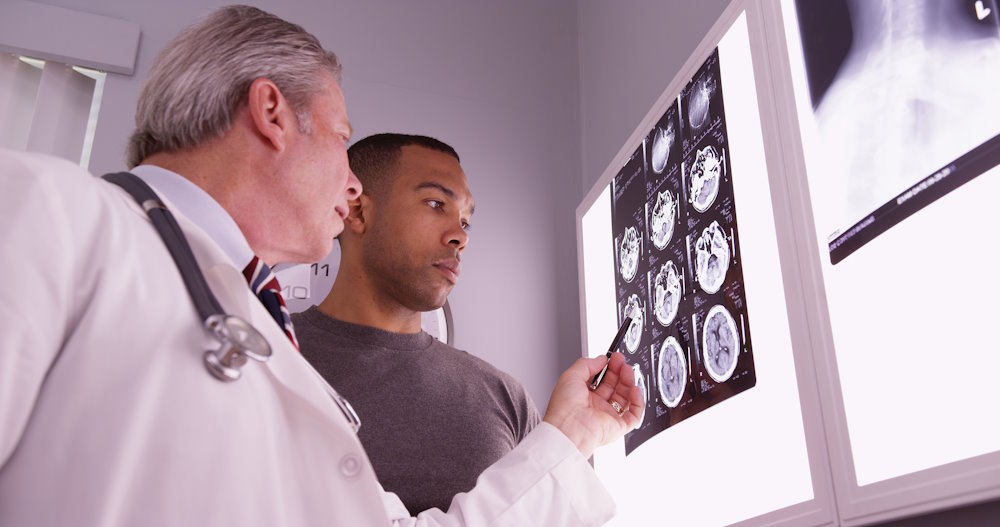 Image of doctor showing patient brain scan images